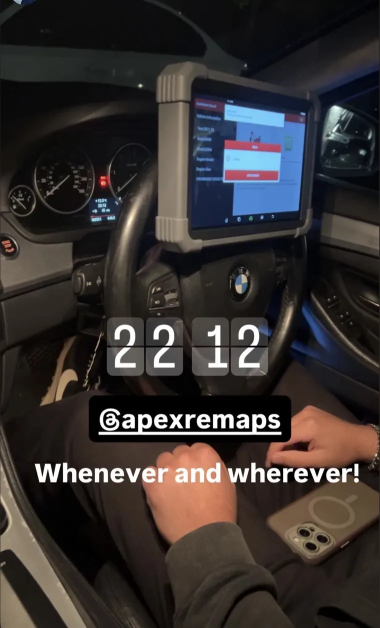 Handheld workshop diagnostic tablet mounted inside a BMW